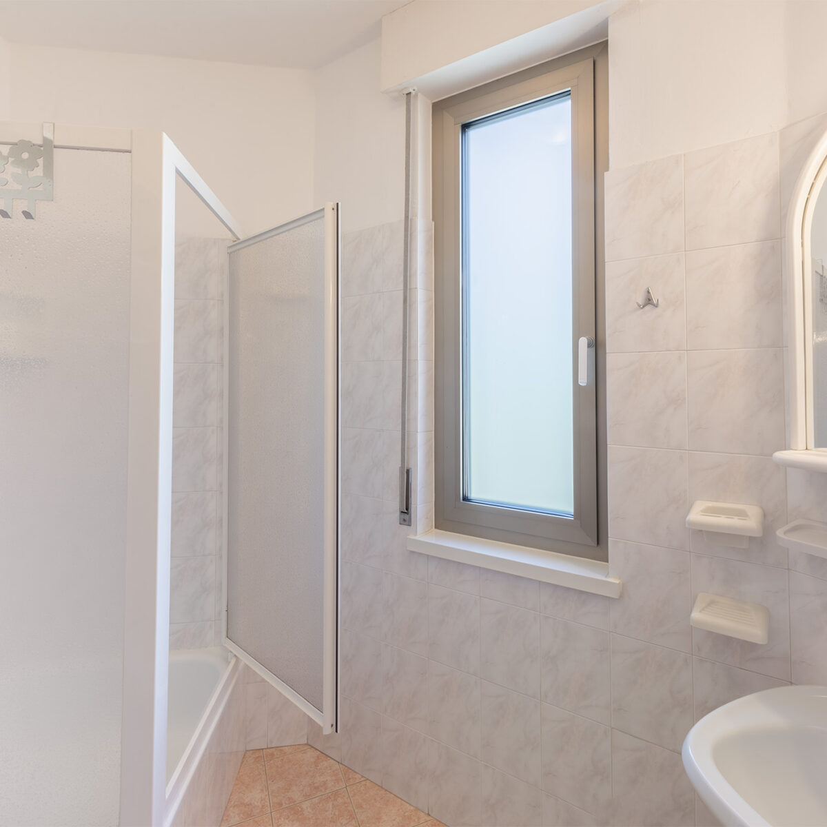The windowed bathroom is equipped with shower, toilet, bidet