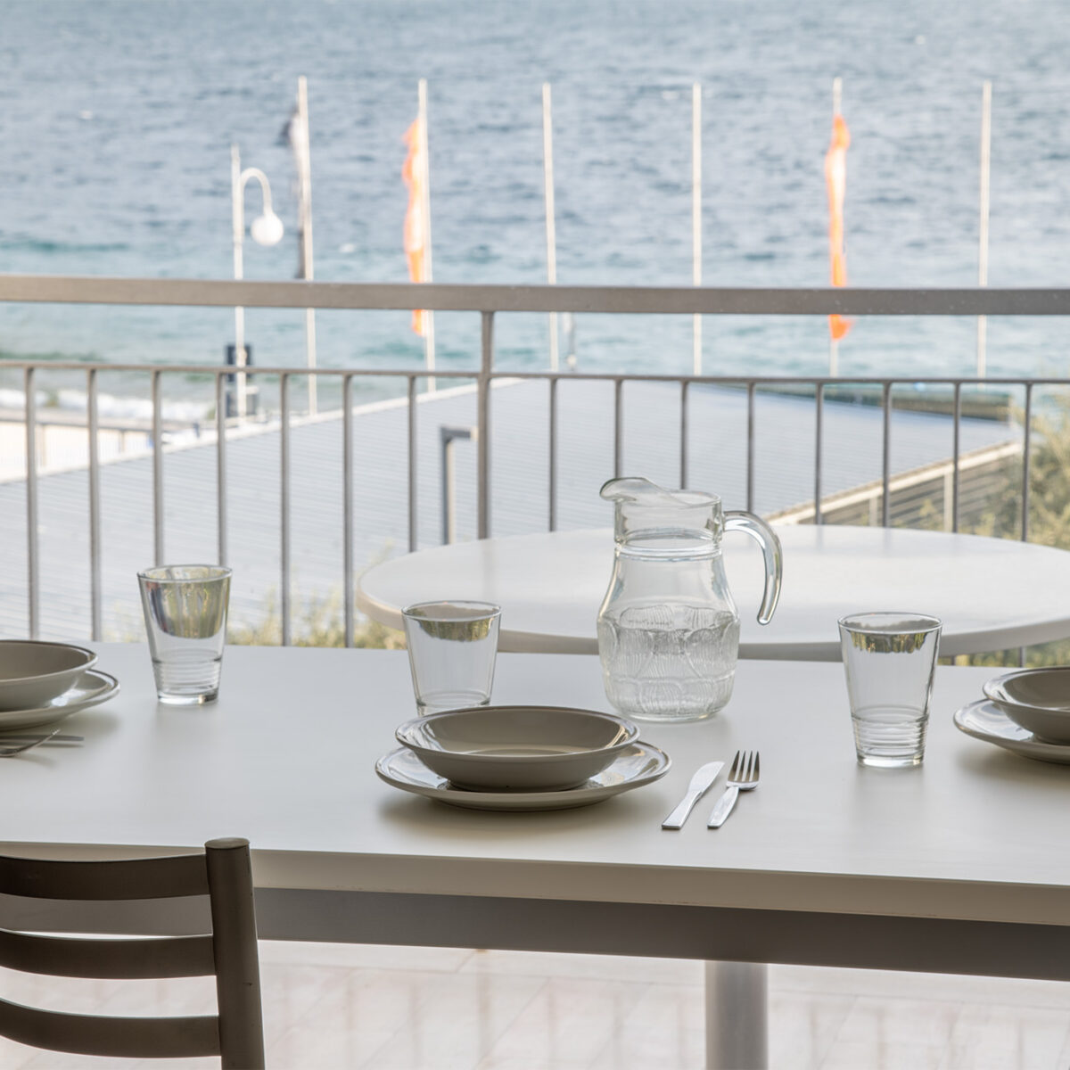 The dining table placed in front of the spacious window